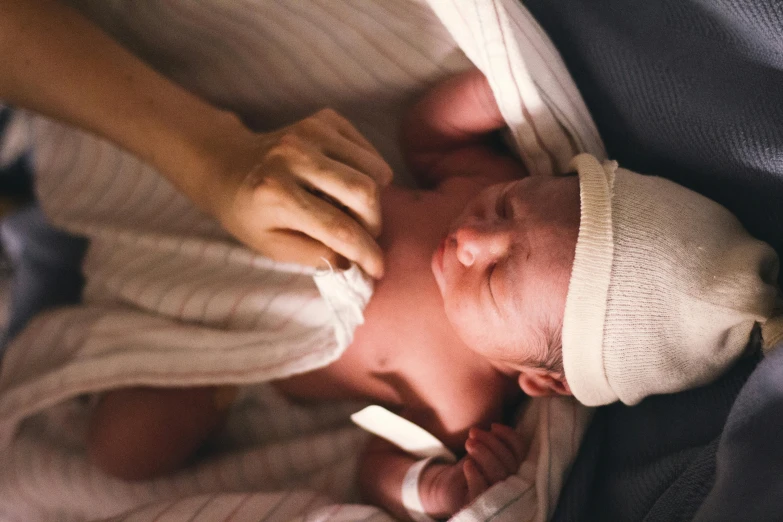 a close up of a person holding a baby, lachlan bailey, birth, thumbnail, frank moth