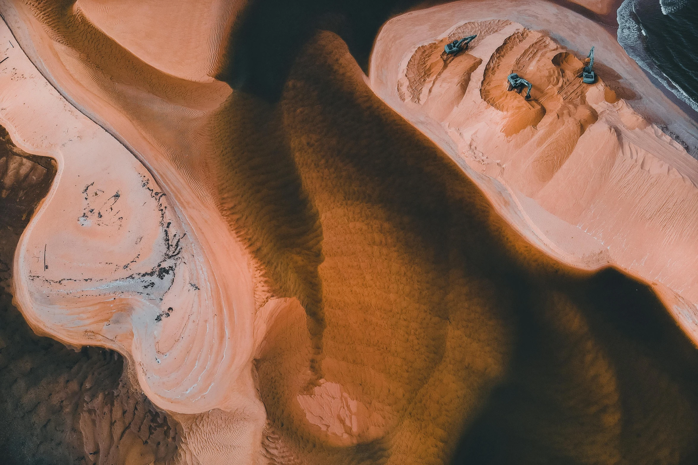 a couple of people laying on top of a sandy beach, an ultrafine detailed painting, pexels contest winner, canyon topography, close-up from above, unsplash transparent fractal, the australian desert