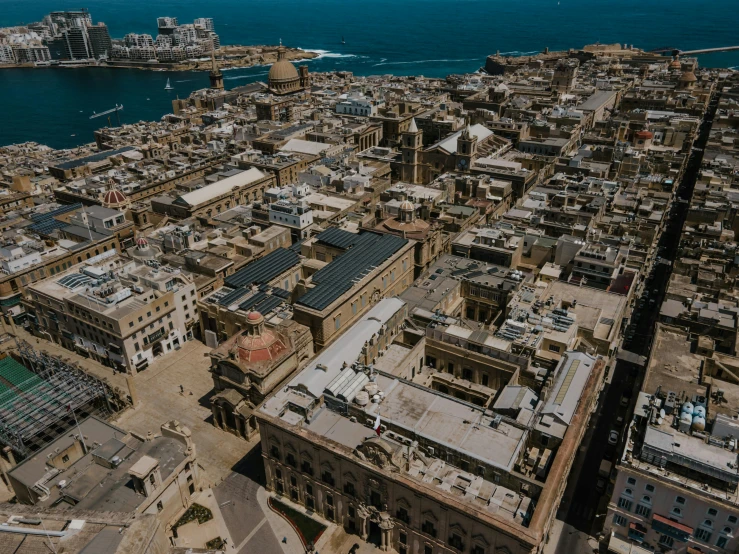 an aerial view of a city next to the ocean, pexels contest winner, renaissance, ancient buildings, brown, cinematic footage, mediterranean