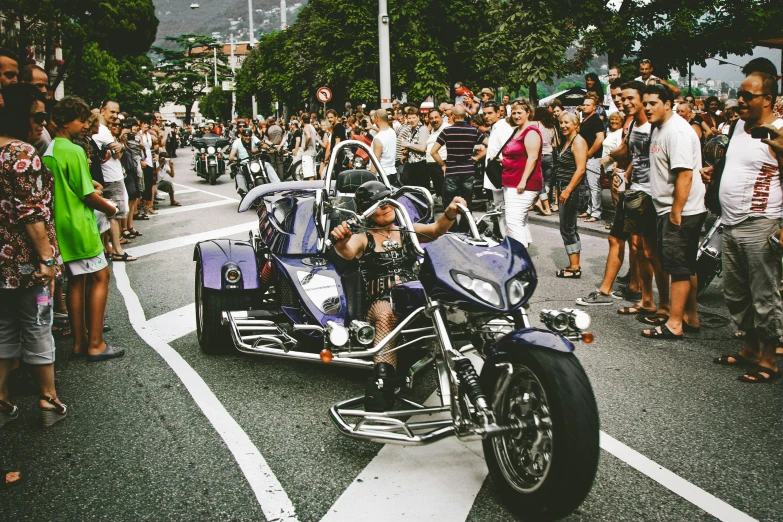 a man riding on the back of a motorcycle down a street, pexels contest winner, pride parade, many exotic cars, avatar image, singapore