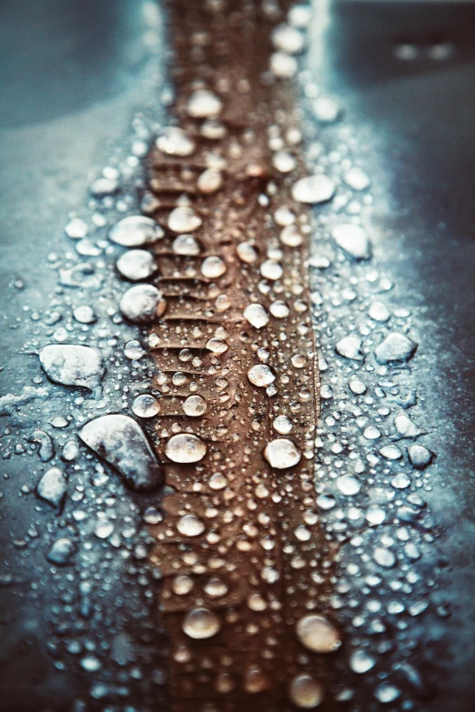 a close up of water droplets on a metal surface, a macro photograph, inspired by Elsa Bleda, unsplash, paul barson, rivets, with crystals on the walls, water - logged