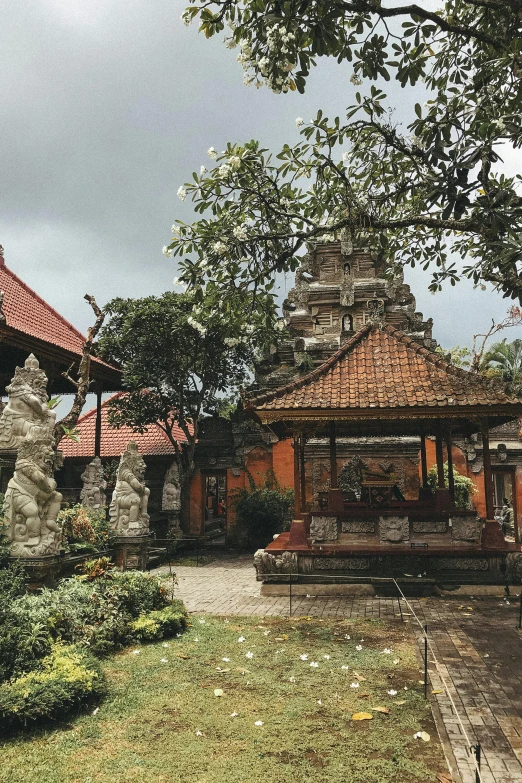 a gazebo sitting in the middle of a lush green park, a picture, by Daniel Lieske, unsplash, ancient indonesia, muddy village square, many stone statues, overcast lighting