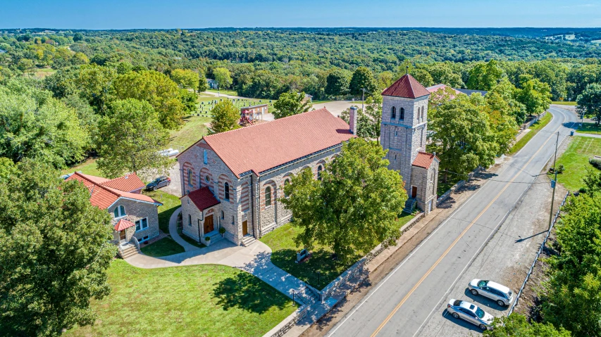 an aerial view of a church surrounded by trees, by Joe Stefanelli, romanesque, view from across the street, restored, listing image, thumbnail