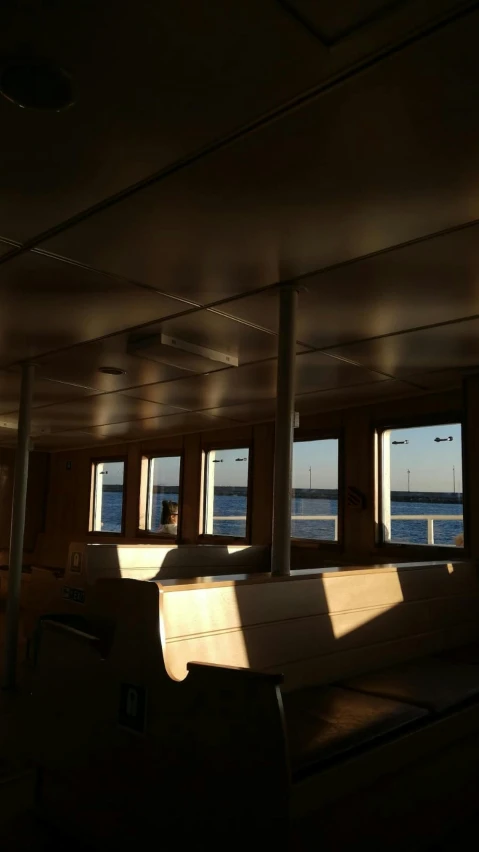 the sun shines through the windows of a boat, by Ben Thompson, low quality photo, full room view, daylight, clean image