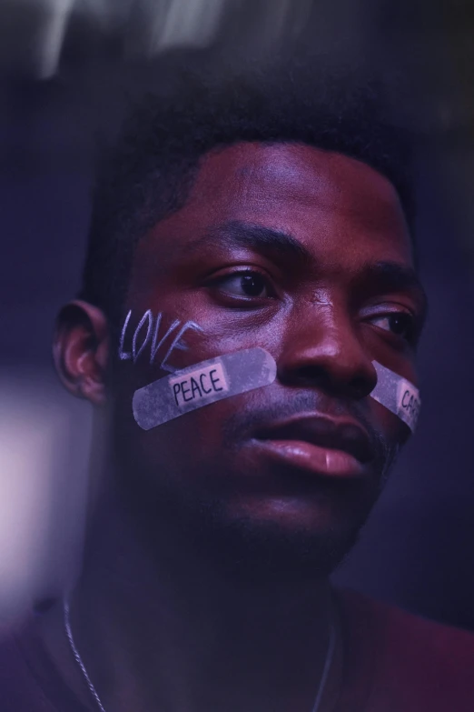 a man with tape on his face, an album cover, inspired by Gordon Parks, trending on pexels, black arts movement, loving stare, still from a live action movie, peace, lush