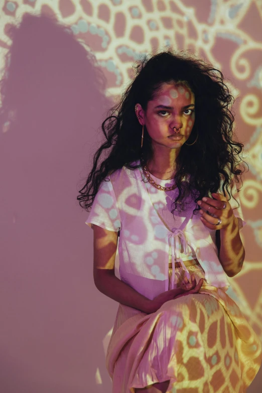 a woman sitting in front of a projection of a giraffe, an album cover, trending on pexels, graffiti, shanina shaik as medusa, pastel lighting, curls, in a glowing skirt