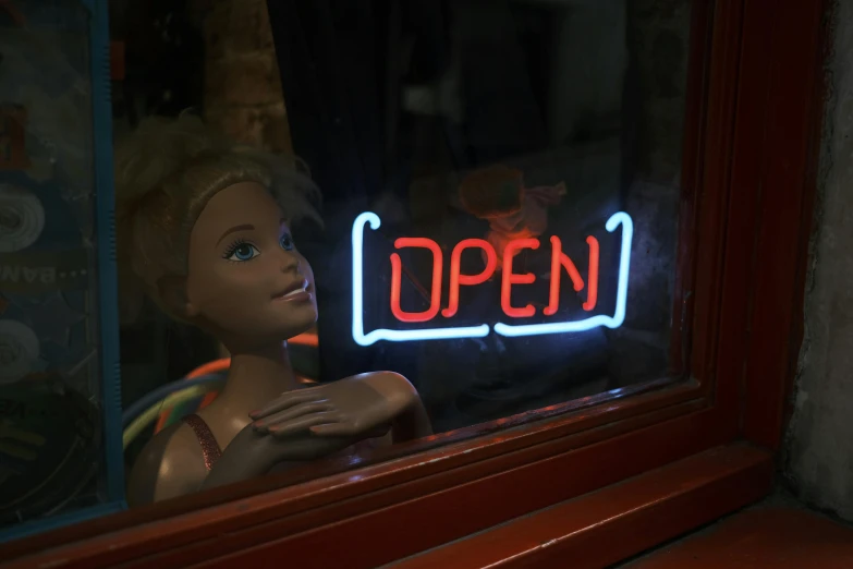 a doll that is sitting in front of a window, neon sign, open plan, shop front, rotoscope