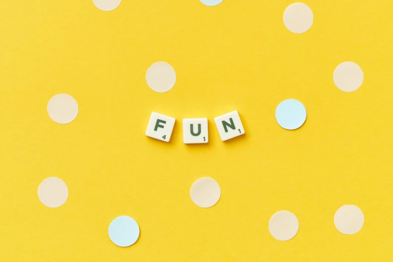 the word fun spelled in scrabbles on a yellow background, by Emma Andijewska, trending on unsplash, polka dot, etsy stickers, background image