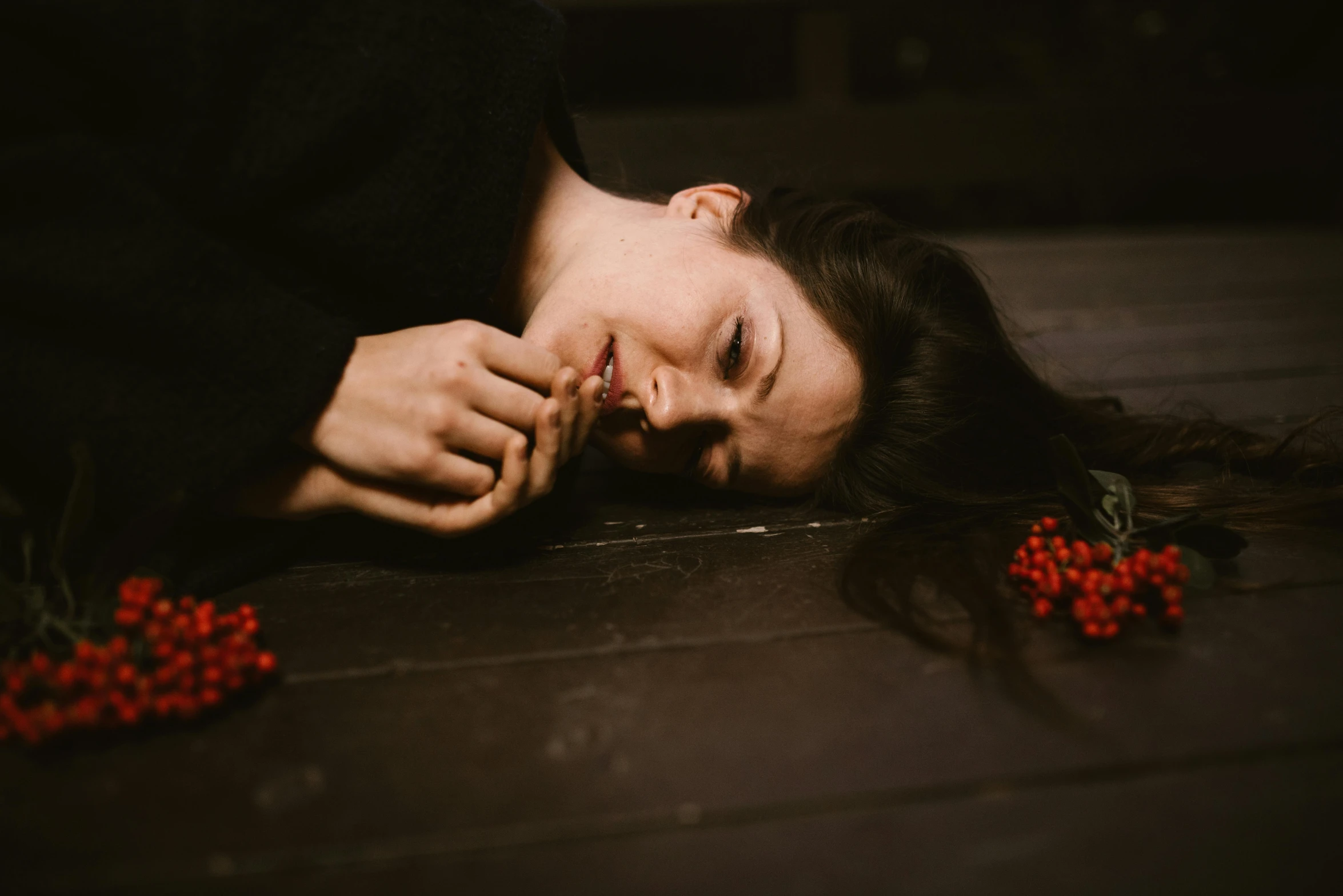 a woman laying on the ground next to a bunch of berries, inspired by Elsa Bleda, pexels contest winner, portrait of mournful, 15081959 21121991 01012000 4k, on wooden table, girl with dark brown hair