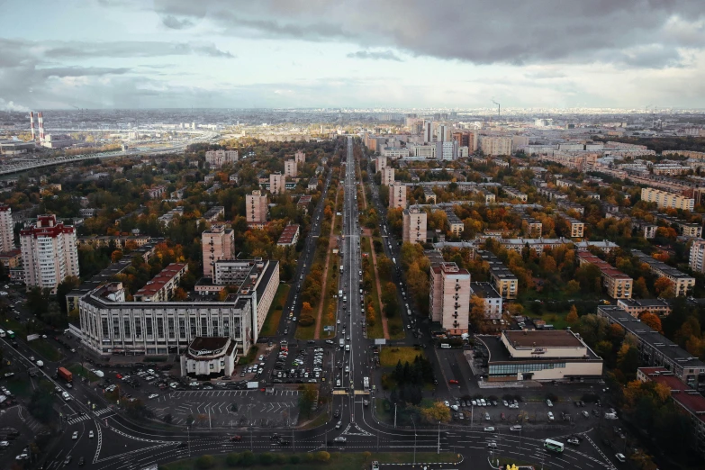 a large city filled with lots of tall buildings, by Andrei Kolkoutine, pexels contest winner, socialist realism, autum, saint petersburg, ultrawide angle cinematic view, фото девушка курит