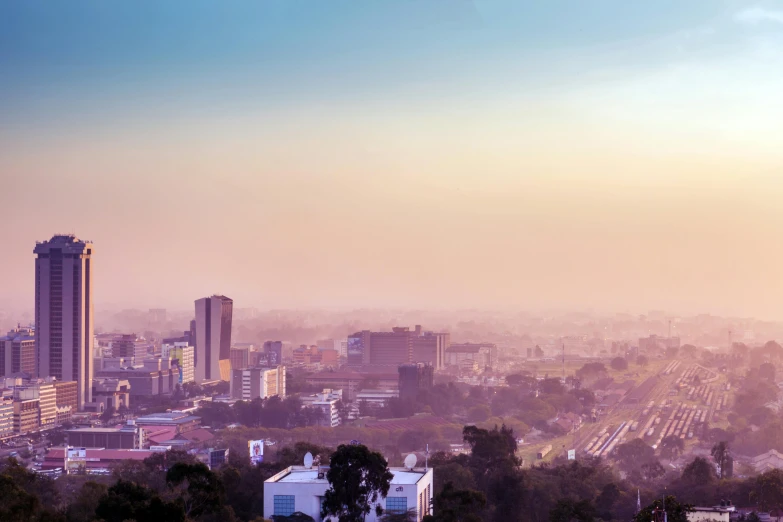 a view of a city from the top of a hill, an album cover, pexels contest winner, hurufiyya, unmistakably kenyan, morning haze, gradient, outdoors tropical cityscape