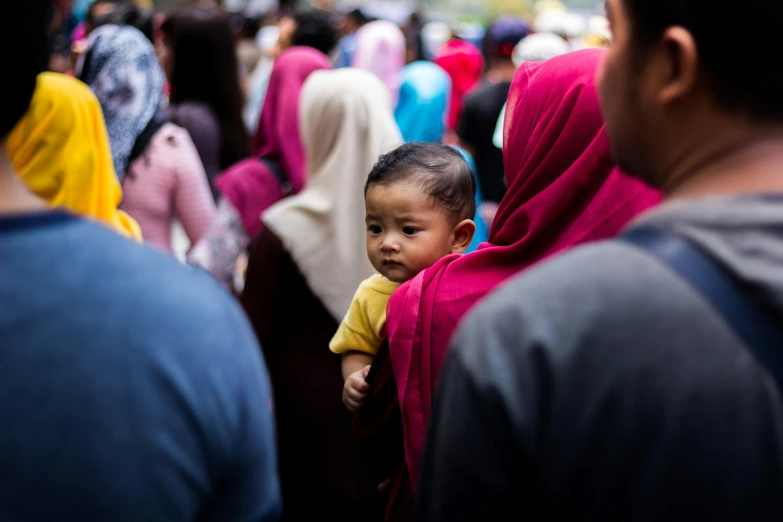 a group of people standing next to each other, by Matija Jama, pexels contest winner, hurufiyya, migrant mother, square, jakarta, over the shoulder