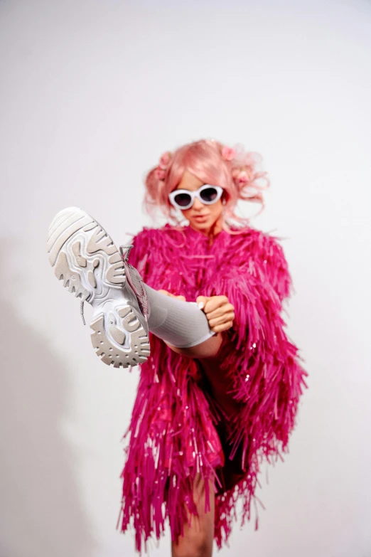 a woman in a pink dress holding a pair of shoes, an album cover, trending on pexels, maximalism, furry character, wig, cosplay photo, model wears a puffer jacket