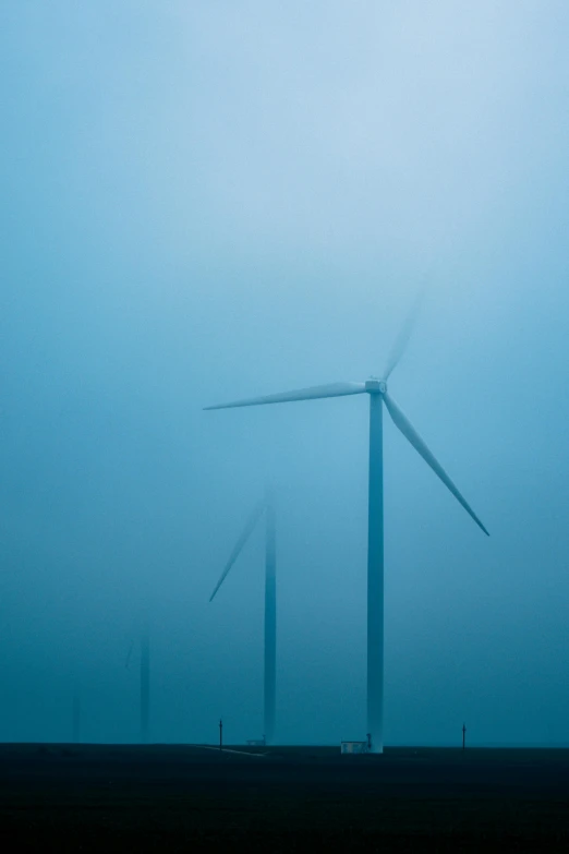 a group of wind turbines in a foggy field, a portrait, by Jan Tengnagel, minimalism, floating. greenish blue, img _ 9 7 5. raw, rectangle, cold