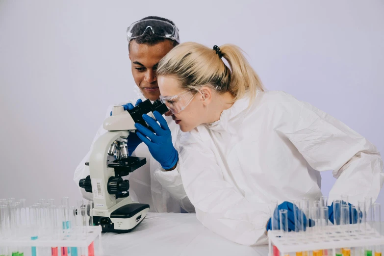 a man and a woman looking into a microscope, by Joe Bowler, pexels contest winner, clean white lab background, background image, gif, nursing