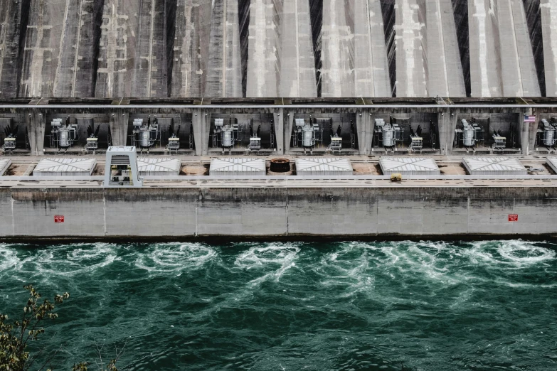 a large body of water next to a dam, by Yasushi Sugiyama, pexels contest winner, renaissance, electric motors, grey, colour photo, thumbnail