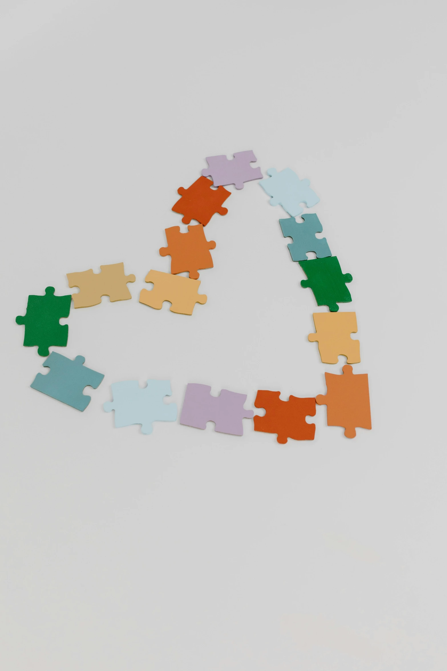 a triangle made of puzzle pieces on a white surface, unsplash, heart, in-game 3d model, 2 5 6 x 2 5 6, muted colors. ue 5