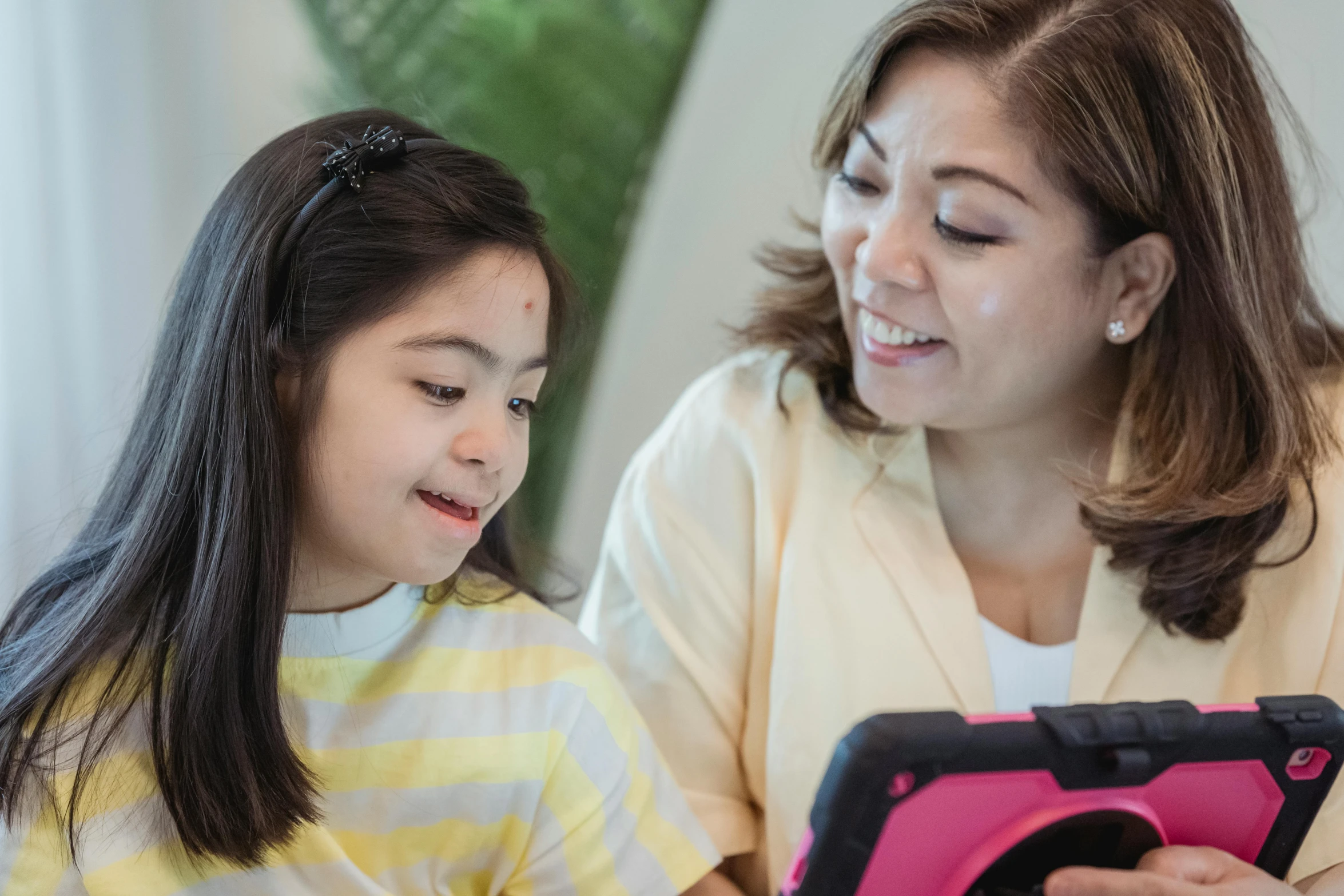 a woman and a young girl looking at a tablet, pexels contest winner, mingei, leni robredo, avatar image, closeup - view, digital image