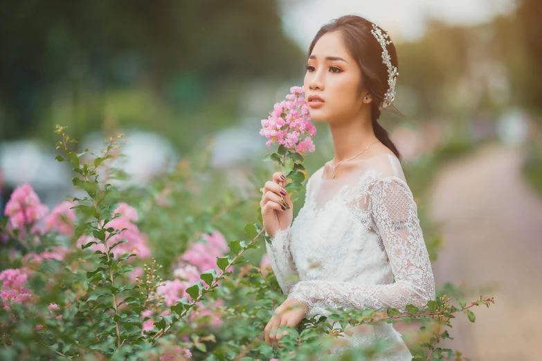 a woman in a wedding dress holding a flower, by Tan Ting-pho, pexels contest winner, romanticism, gorgeous young korean woman, field of pink flowers, youtube thumbnail, woman with braided brown hair