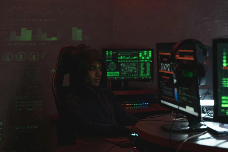 a man sitting in front of two computer monitors, pexels, computer art, hacking into the mainframe, nighttime, h3h3, threyda