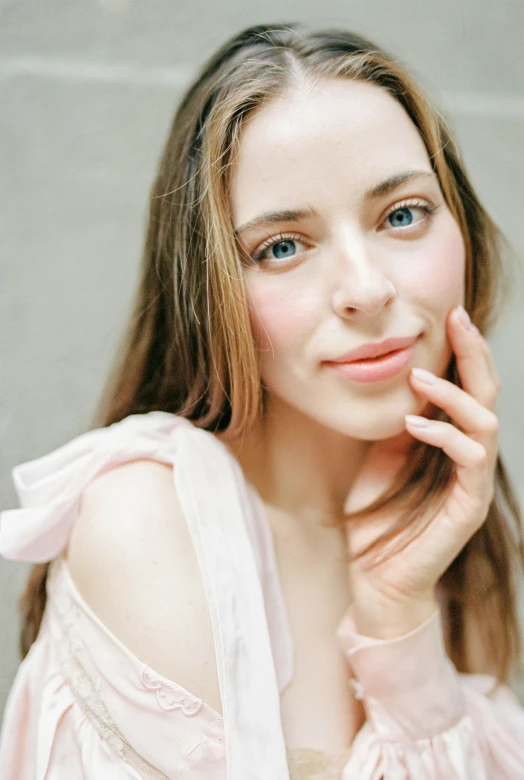 a woman in a pink dress posing for a picture, by Nicolette Macnamara, diffused natural skin glow, natural soft pale skin, close up at face, promo image