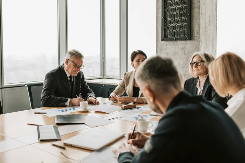 a group of people sitting around a wooden table, pexels contest winner, corporate boss, background image, older male, court session images