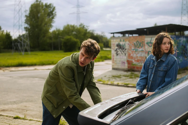 a couple of people standing next to a car, by Jacob Toorenvliet, happening, stanger things, broken down, teenage boy, promo image