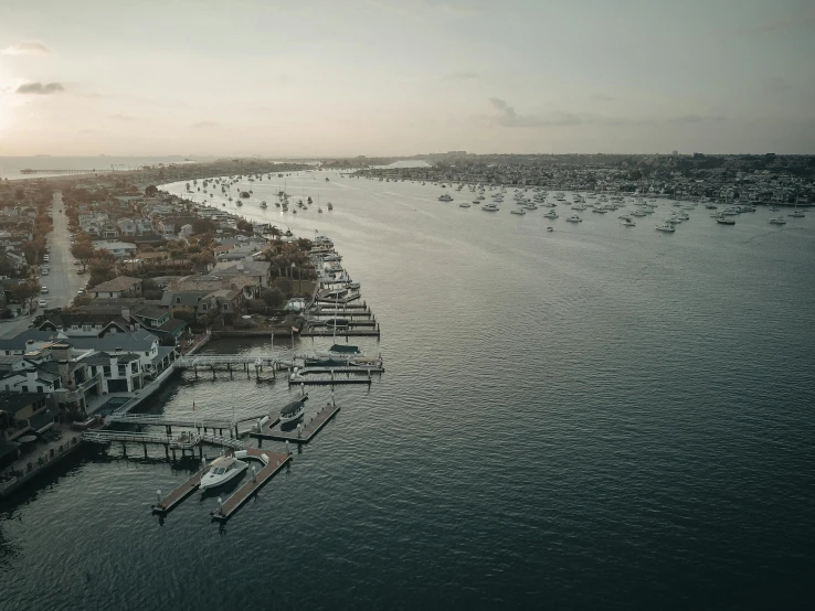 a large body of water filled with lots of boats, by Ryan Pancoast, pexels contest winner, hurufiyya, manly, low quality footage, the city of santa barbara, slight overcast