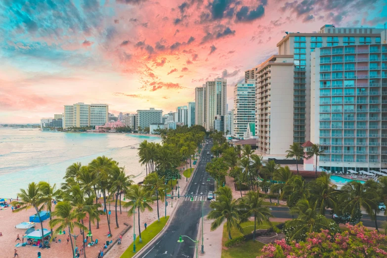 a street lined with palm trees next to the ocean, pexels contest winner, hurufiyya, waikiki beach skyline, pink clouds in the sky, aerial view of a city, schools