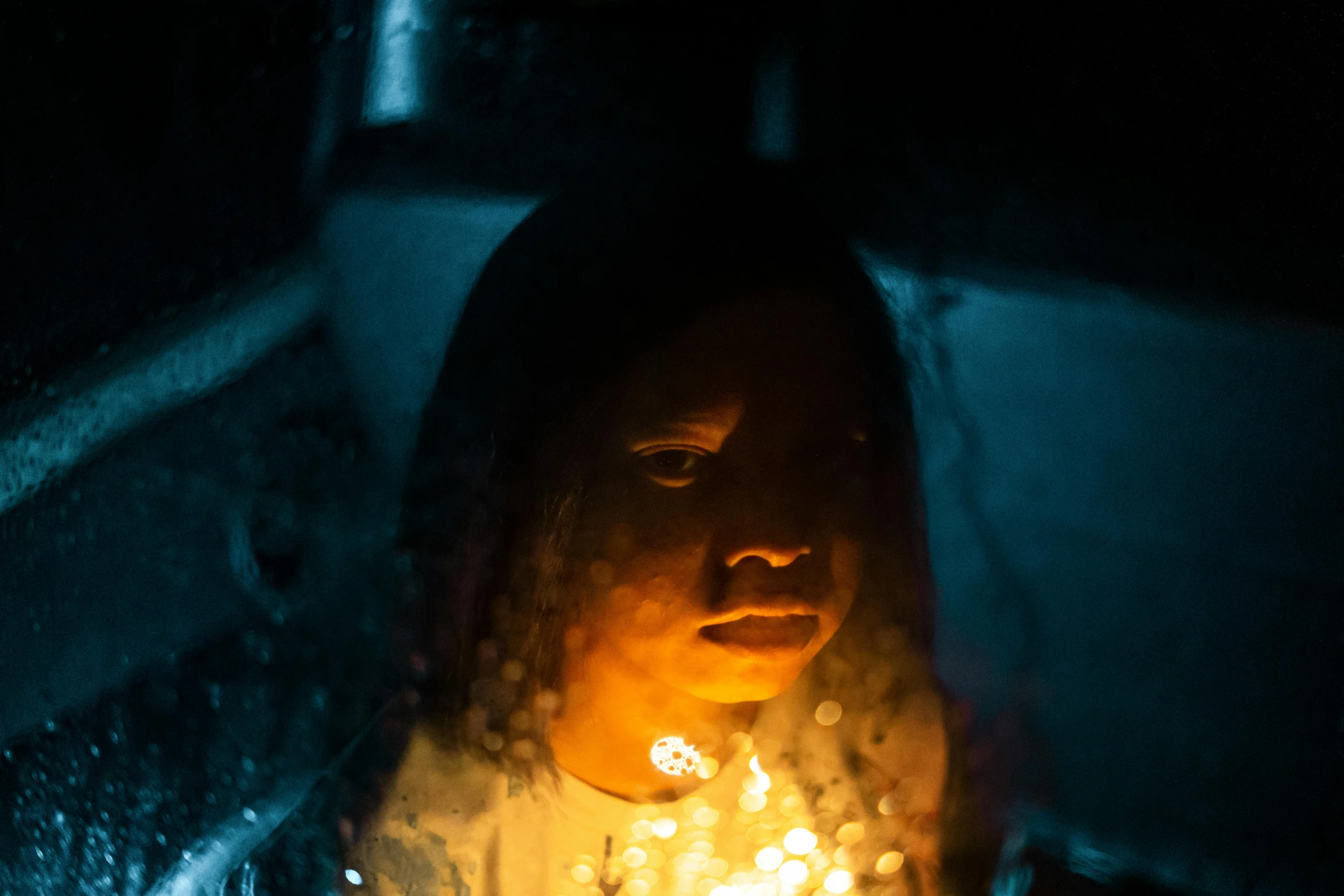 a woman sitting in the back seat of a car in the rain, an album cover, inspired by Elsa Bleda, pexels contest winner, art photography, glowing yellow face, emerging from her lamp, aida muluneh, crystallized human silhouette