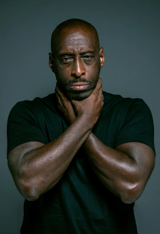 a man in a black shirt posing for a picture, inspired by Terrell James, lance reddick, paul barson, demur, pensive