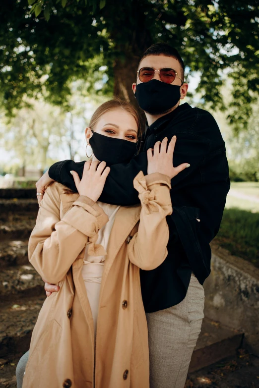 a man and a woman standing next to each other, trending on pexels, white man with black fabric mask, hug, russian girlfriend, jacket