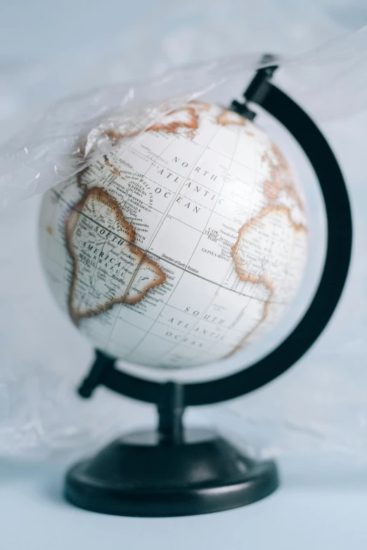 a globe sitting on top of a table covered in plastic