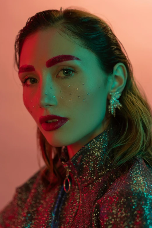 a woman with glitter on her face, an album cover, inspired by Elsa Bleda, trending on pexels, holography, gemma chan girl portrait, androgynous person, mahira khan as a mage, red neon details