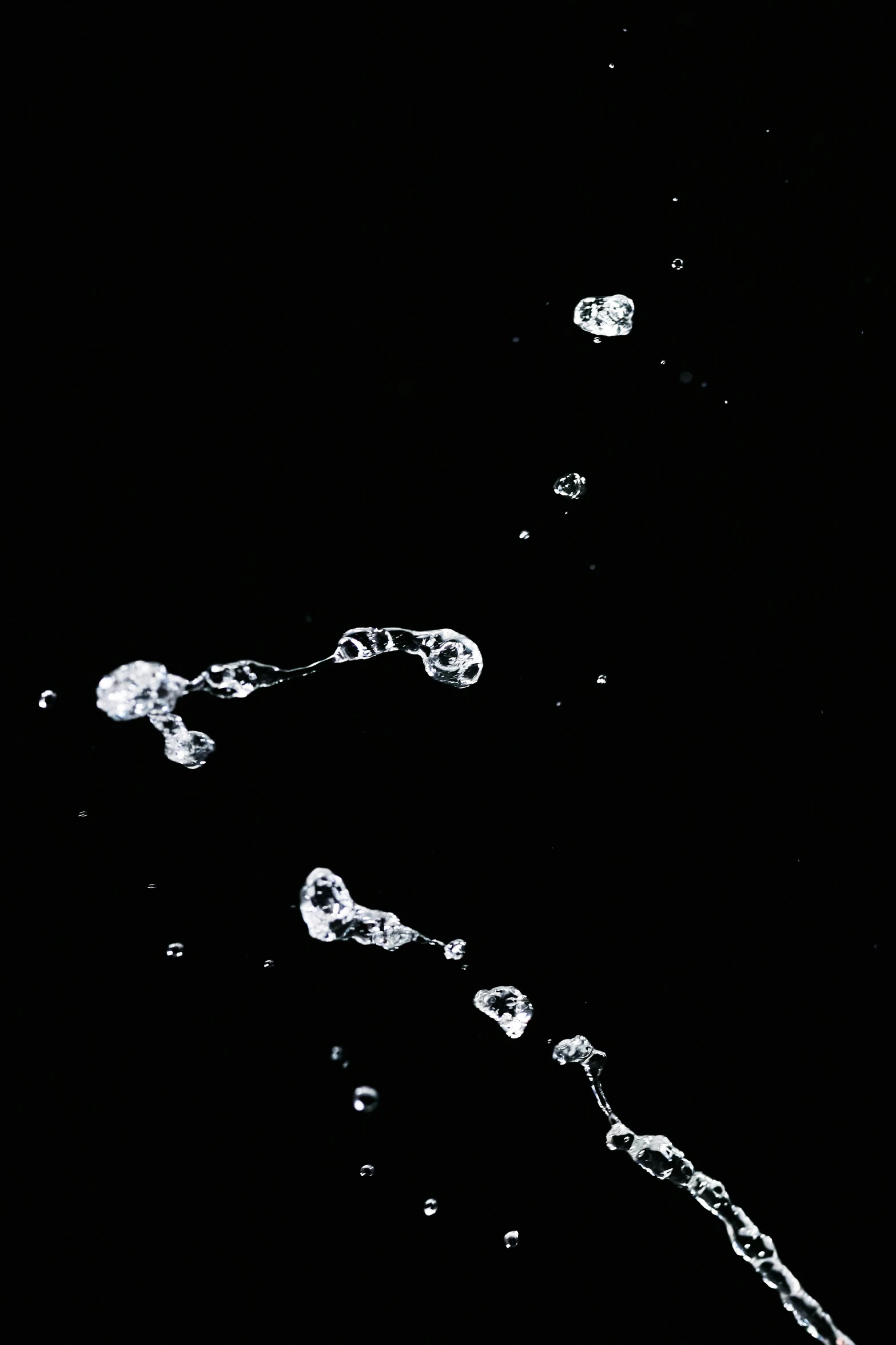 a close up of a toothbrush with water coming out of it, a microscopic photo, inspired by Lucio Fontana, white ink sketch on black paper, floating bubbles, ffffound, floating rocks