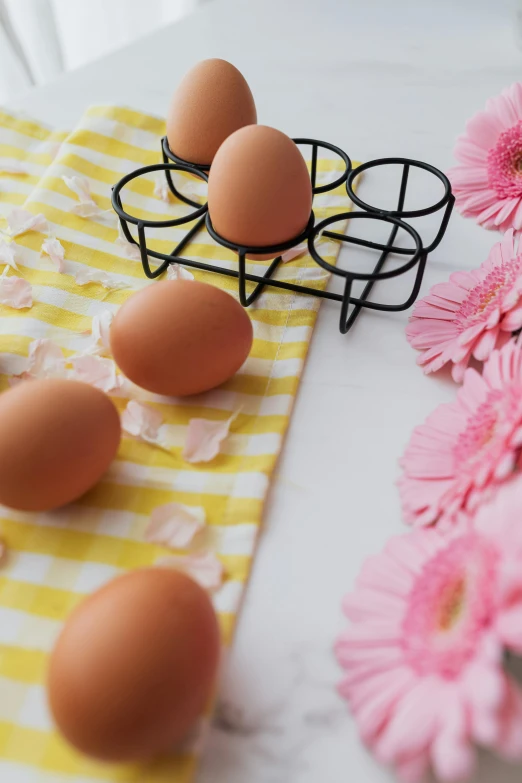 a bunch of eggs sitting on top of a table, flowers in background, instagram picture, promo photo, cooking