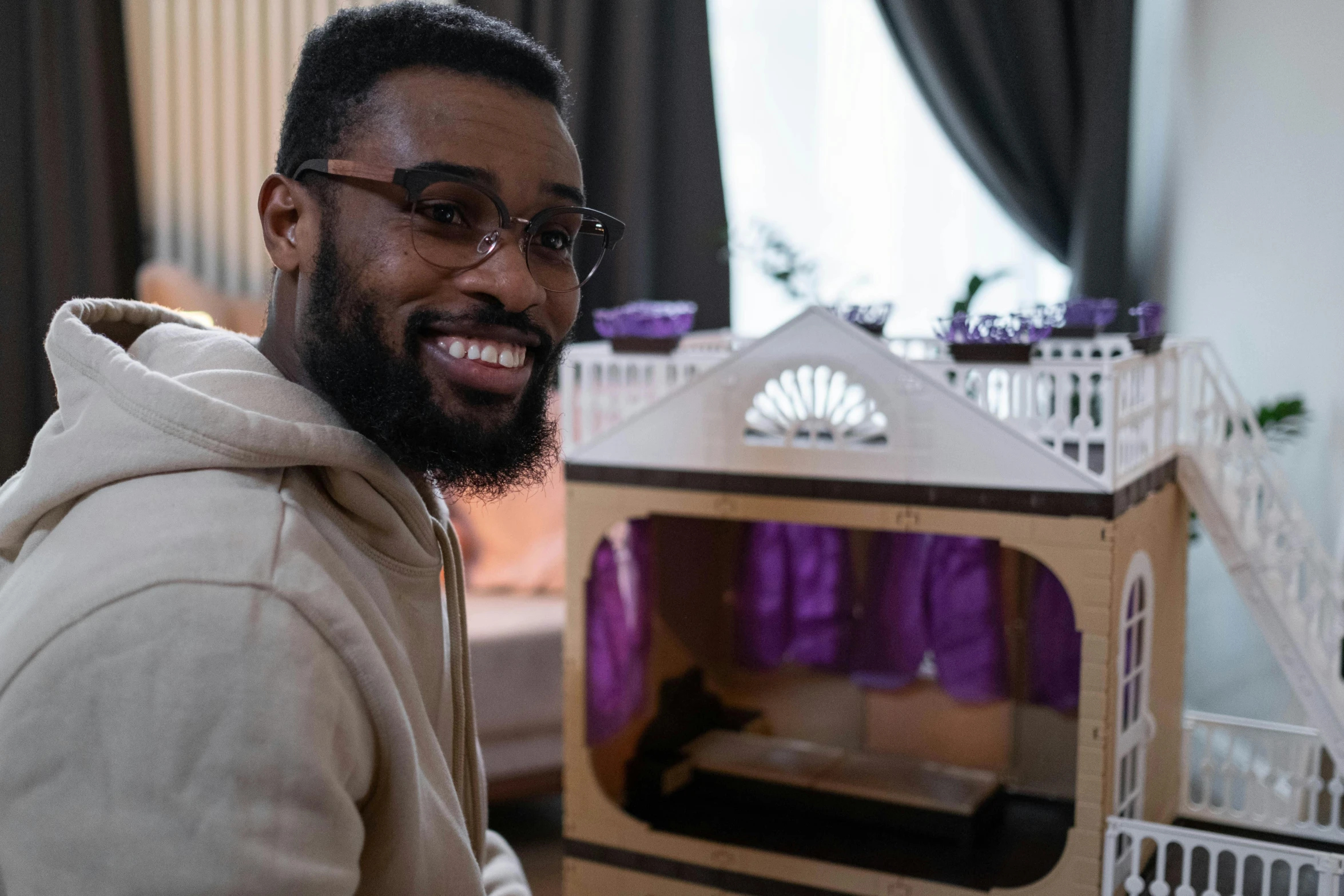 a man that is standing in front of a doll house, inspired by Frank Mason, pexels contest winner, mkbhd, smiling man, caleb from critical role, still frame from a movie