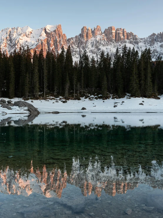 a body of water with a mountain in the background, by Sebastian Spreng, pexels contest winner, lago di sorapis, winter setting, panoramic, highly reflective light