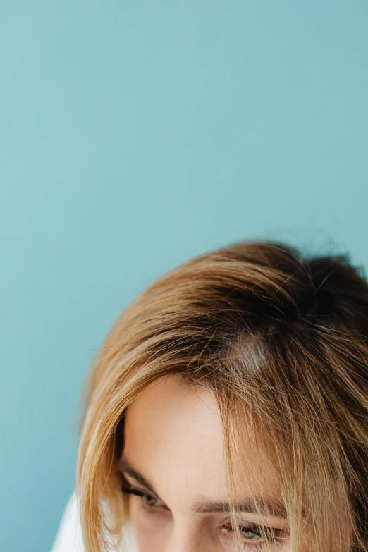 a woman brushing her teeth with a toothbrush, an album cover, trending on pexels, renaissance, hair texture, blonde hair human head, with a blue background, side view close up of a gaunt