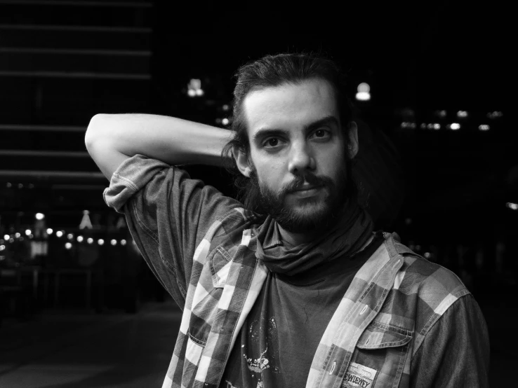 a black and white photo of a man with a beard, by Pablo Rey, wearing a flannel shirt, valentina remenar, phosphorescent, michal