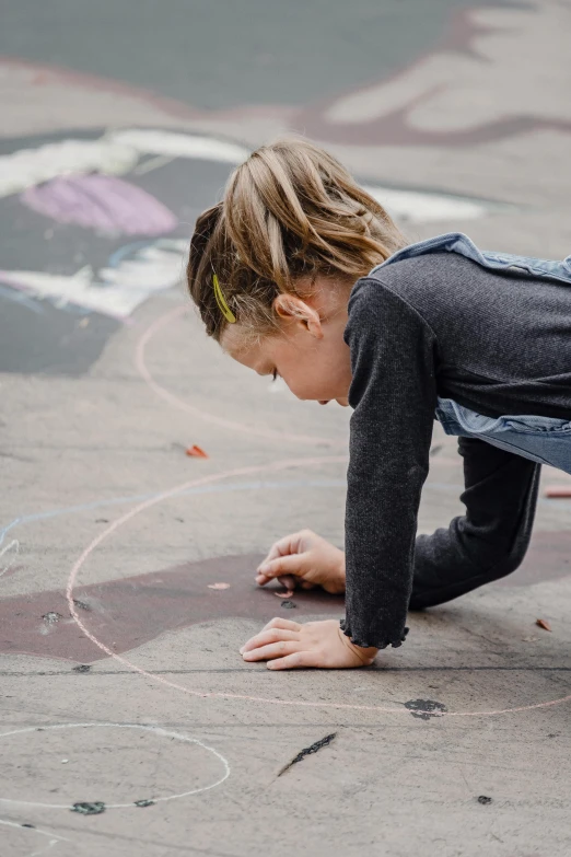 a little girl drawing on the sidewalk with chalk, pexels contest winner, interactive art, paul barson, ilustration, multiple stories, in an urban setting
