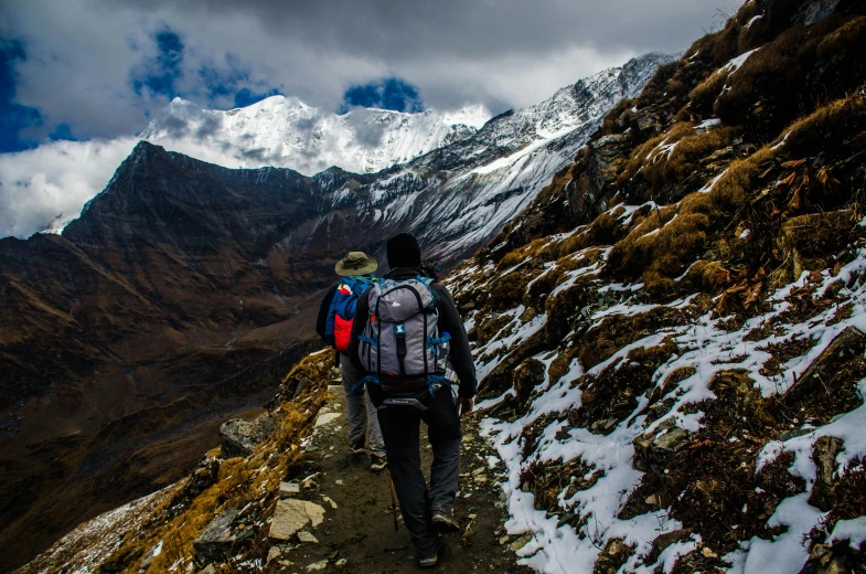 a man walking up the side of a snow covered mountain, pexels contest winner, nepal, thumbnail, with a backpack, avatar image