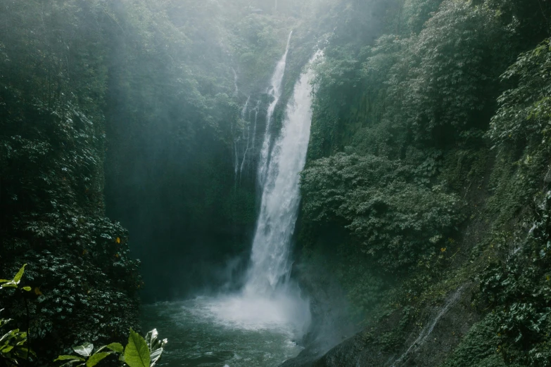 a waterfall in the middle of a lush green forest, pexels contest winner, hurufiyya, coban, water particles, grey, conde nast traveler photo