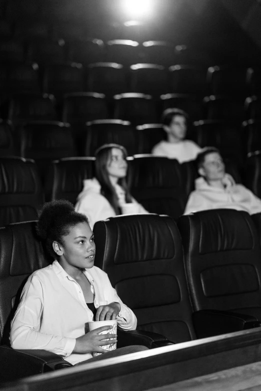 a group of people sitting in a movie theater