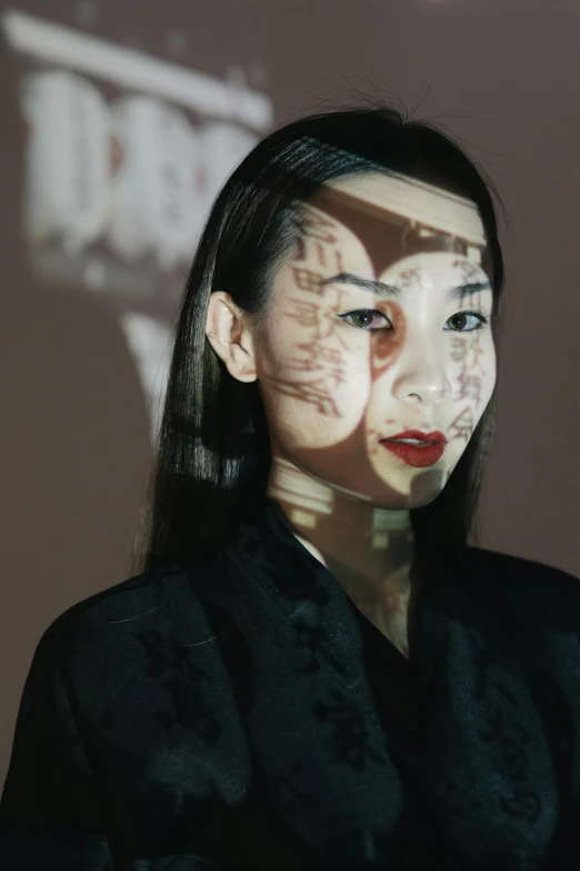 a woman standing in front of a projection screen, inspired by Taro Yamamoto, video art, detailed face of a asian girl, transparent face, sui ishida with black hair, medium close up portrait