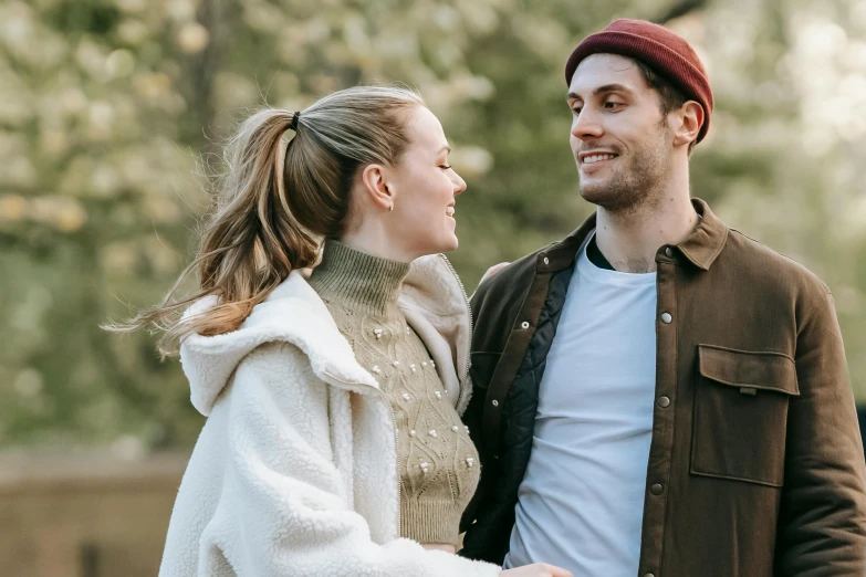 a man and a woman standing next to each other, trending on pexels, renaissance, in the park, sydney hanson, happy cozy feelings, looking to his side