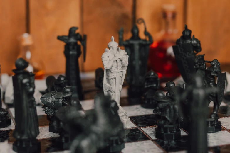 a close up of a chess board with statues on it, a marble sculpture, pexels contest winner, renaissance, dressed as a knight, abbey warhammer battle, on a coffee table, ice and fire