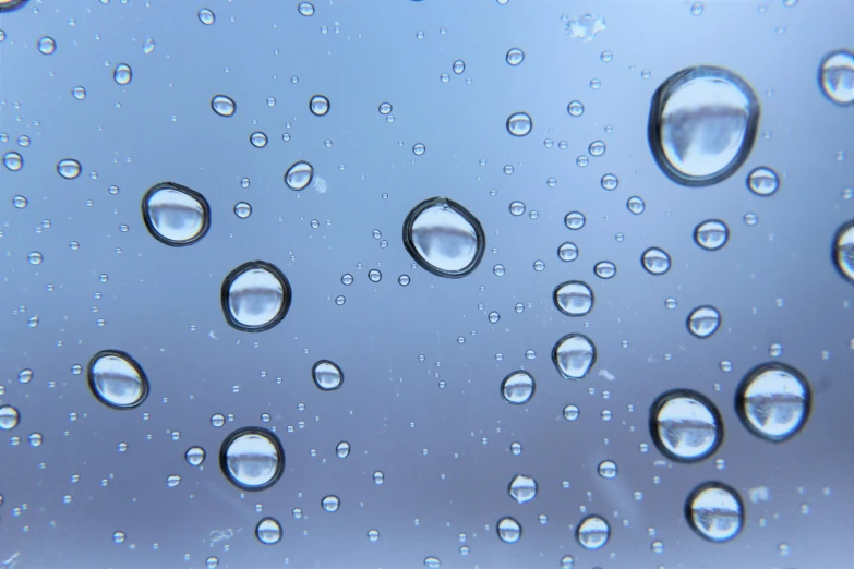 a close up of water droplets on a window, pexels, photorealism, blue moon ray tracing, smooth surface render, ilustration, low-angle