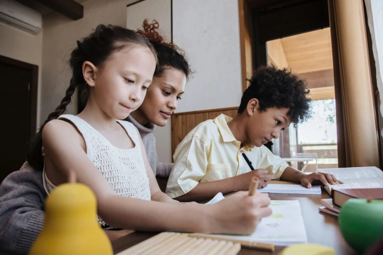 a couple of kids that are sitting at a table, a child's drawing, pexels contest winner, husband wife and son, studying, te pae, varying ethnicities