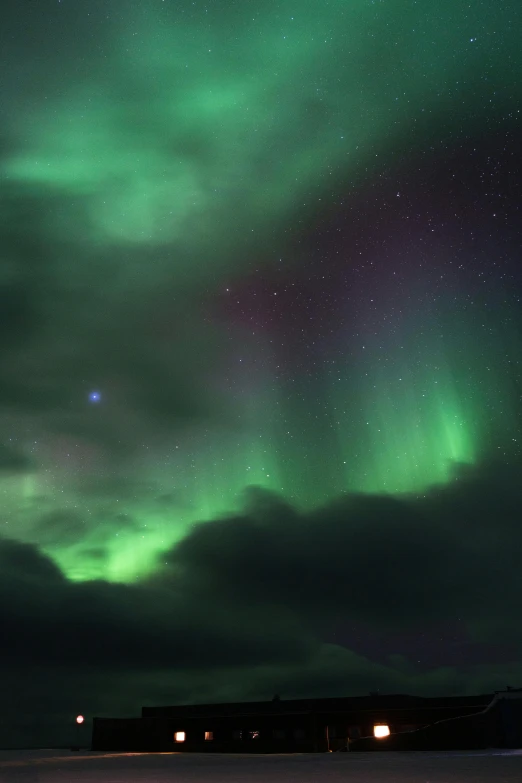 a green and purple aurora bore over a body of water, by Ejnar Nielsen, pexels contest winner, square, in the clouds, closeup!!!!!!, reykjavik